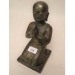 Antique patinated bronze figure of kneeling Buddha with traces of gilt and vertdegris, 9ins high