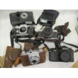 Box containing a quantity of various vintage cameras and lenses including Nikon, Shimano, Canon etc.