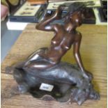 20th Century bronze patinated figure of a young nude female sitting on a shell, 9ins high x 12.