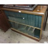 Mid 20th Century bookcase housing a set of Encyclopedia Britannica with leather spines