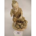 Japanese Meiji period carved ivory figure of a crouching man with baskets of shells, signed to the