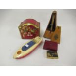 Sutcliffe tin plate model motor boat, a French metronome, a biscuit tin with calendar to the lid and