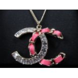 Chanel diamante and pink leather woven gold tone CC pendant on chain, with original packaging In