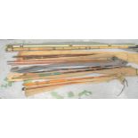 Group of five antique bamboo and resin fishing rods with cloth cases