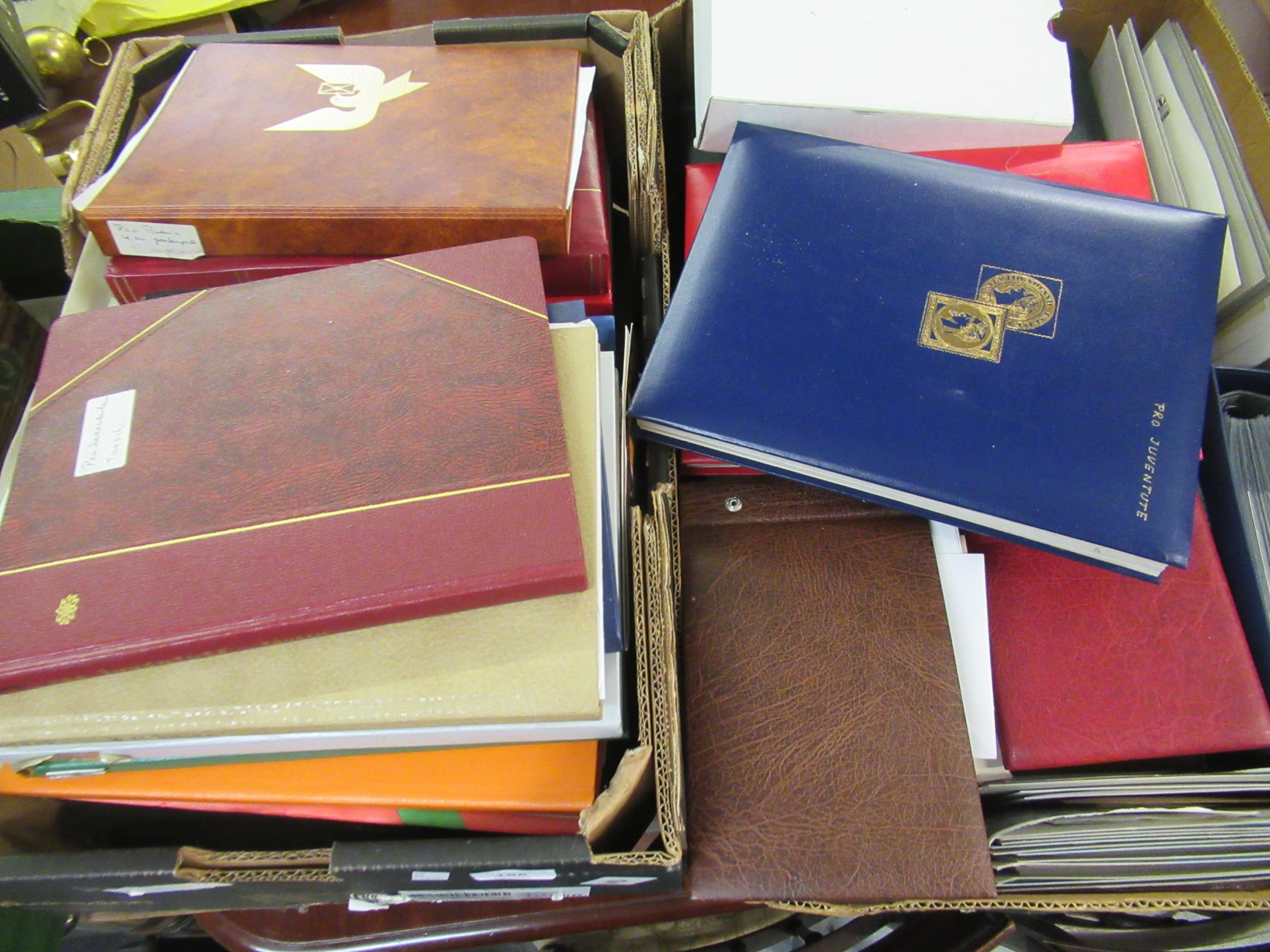 Two boxes containing a large collection of various World stamps in albums and a quantity of First