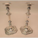 Pair of George V silver tapering and fluted stem candlesticks on octagonal plinth bases, Sheffield