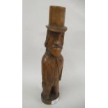 Carved Folk Art figure, possibly American, of a man wearing a top hat and carrying a bag, 13.5ins