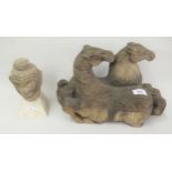 Far Eastern carved wooden group of two horses together with a carved stone Buddhistic head