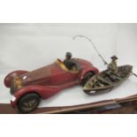 Large composite model of a racing car together with a composite model of a boat with angler