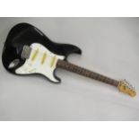 Squier Stratocaster made in Korea and finished in black, together with a hard case Various cracks to