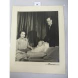 Large format portrait photograph of the young Princess Elizabeth and Prince Philip with baby