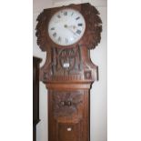 19th Century Continental oak longcase clock, the floral carved hood with a bar glazed pendulum