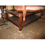 Modern hardwood rectangular coffee table with a glass inset top on square cut supports with