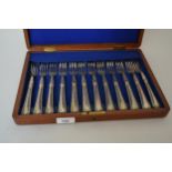 Cased set of twelve, Sheffield silver Victorian fish forks with engraved decoration Case is in