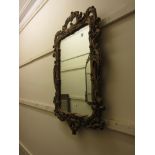 Reproduction gilt framed cartouche shaped wall mirror together with a similar shield shaped mirror