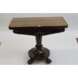 Early Victorian rosewood fold-over card table on tapering column support, with circular base and