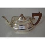 Silver teapot of oval baluster form in late Georgian style, with a gadroon rim, composite handle and
