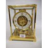 Jaeger LeCoultre ' Atmos ' clock, the gilt brass four glass case enclosing a white enamel dial