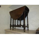 Small early 20th Century oak oval gateleg table on barley twist supports, together with a pair of