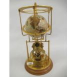 Franklin Mint Smithsonian Institution Cosmochronotrope clock, together with a reproduction