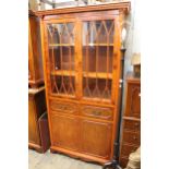 Reproduction yew wood tall bookcase with two astragal glazed doors above two drawers and two panel