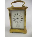 19th Century gilt brass two train carriage clock, striking on a bell, having a enamel dial with