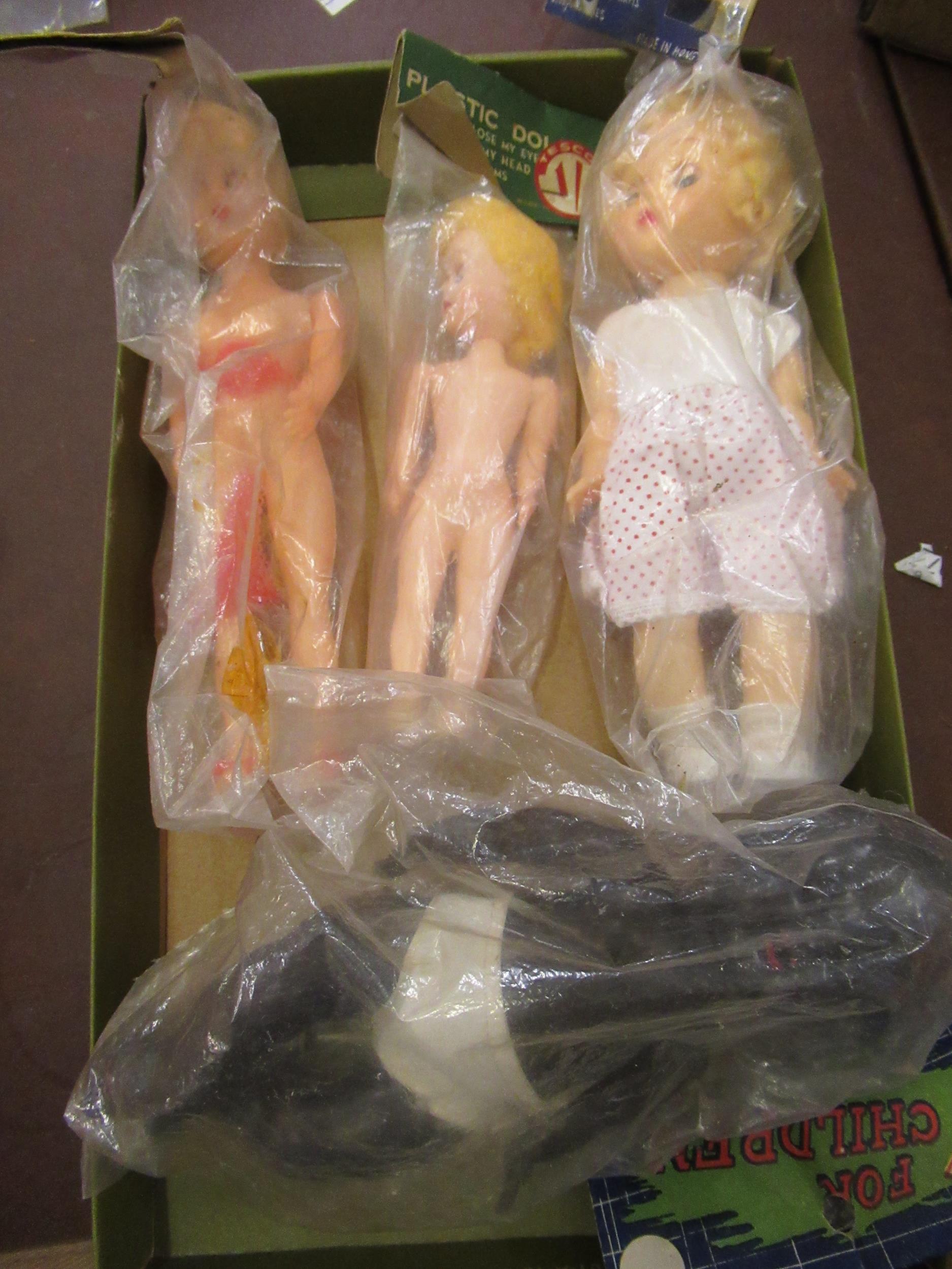 Four various small celluloid dolls in original packaging