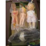 Four various small celluloid dolls in original packaging