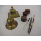 Two brass inkwells, three small leather travelling inkwells and three quill pens