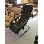 Black painted wrought iron rocking chair with black button upholstered seat