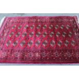 Silk Tekke rug with three rows of ten gols on a wine red ground with borders, 75ins x 54ins