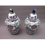 Pair of 20th Century Belgian Delft ware octagonal covered jars with an all-over floral stylised