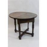 Antique fruitwood and oak circular drop leaf corner table, on baluster turned supports, with
