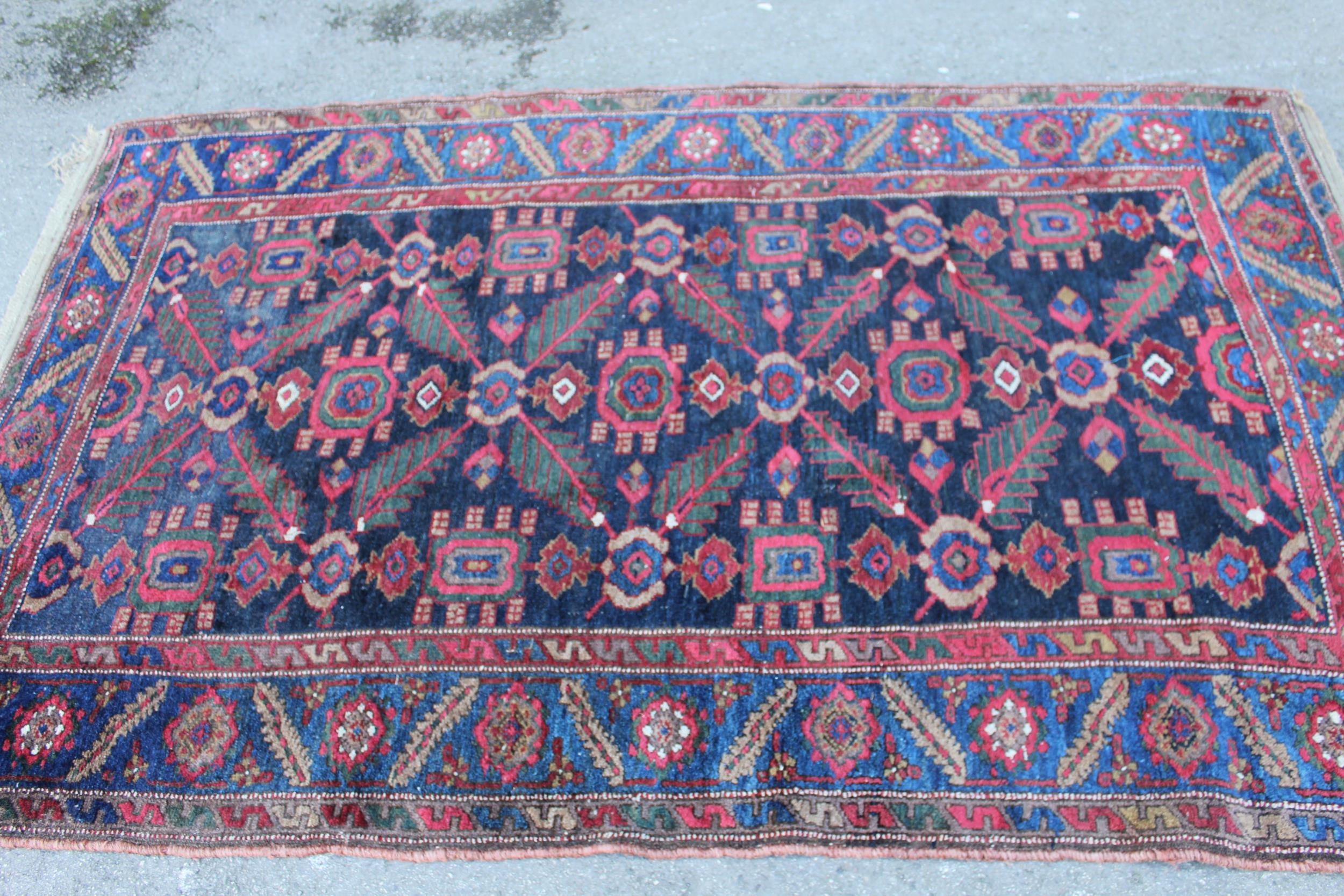 Antique Kurdish rug, having all over stylised floral design, midnight ground with multiple