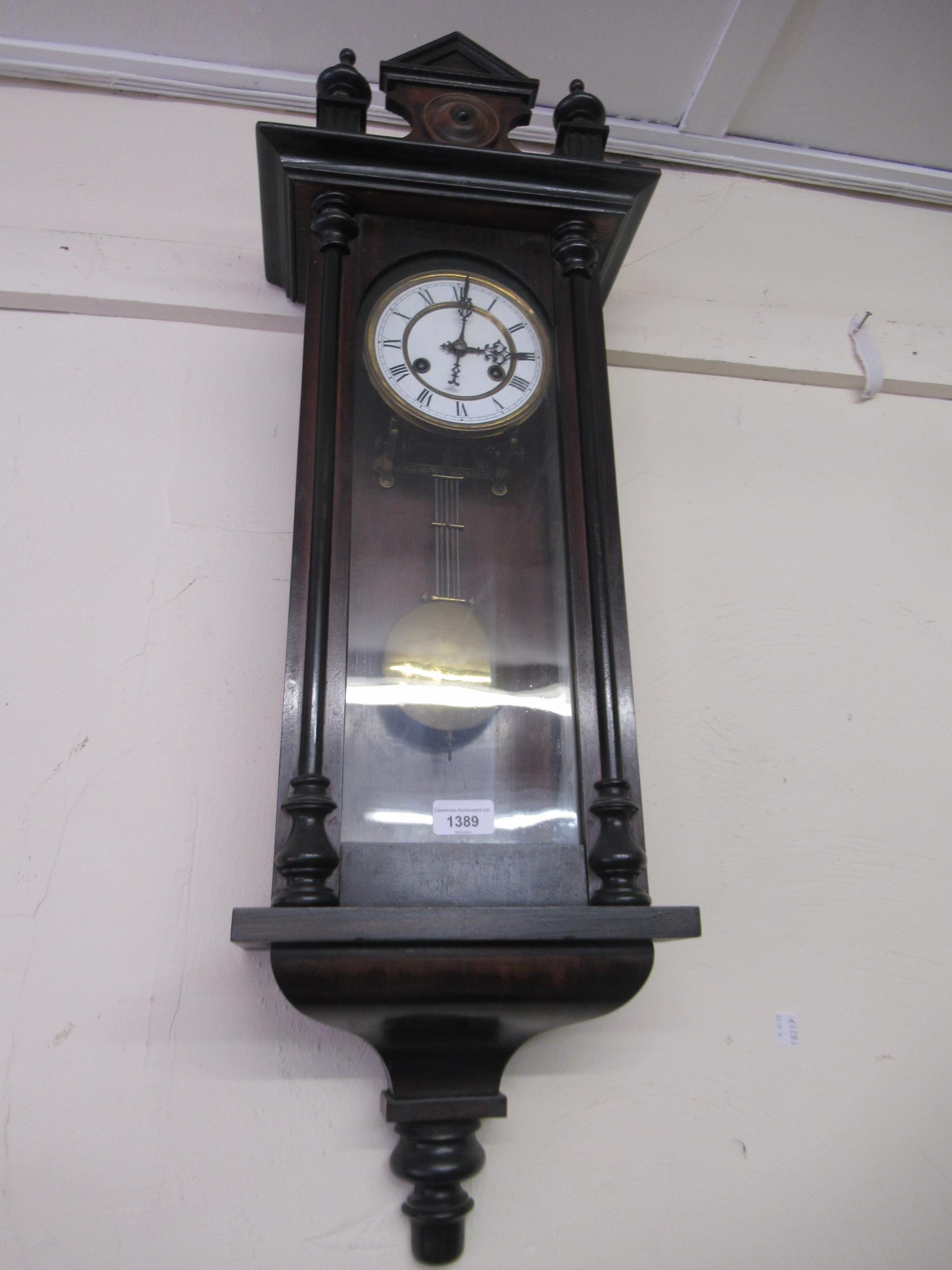 Small late 19th Century Vienna type wall clock, the shaped surmount above a circular enamel dial