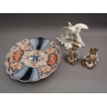 Continental white porcelain group of two birds together with a pair of bisque porcelain nodding head