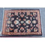 Small Afghan Ziegler mat with a floral design on a dark ground, 2ft 10ins x 2ft 2ins