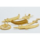 Three Omani yellow metal dagger brooches together with two similar pendants, 22.5g Not tested,
