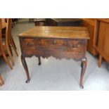 18th Century oak lowboy having three plank moulded top above three short drawers with brass swan