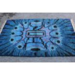 Mid 20th Century long pile rug with an abstract design in shades of blue, purple and black, possibly
