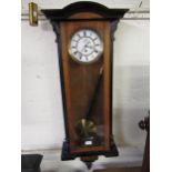 Vienna walnut and ebonised wall clock, the white enamel dial with Roman numerals and subsidiary