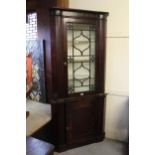 19th Century mahogany and brass inlaid floorstanding corner cabinet in Regency style, with a moulded