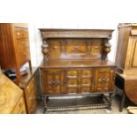 Good quality early 20th Century oak sideboard of Jacobean style, the canopy back with baluster