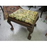 Reproduction mahogany rectangular footstool with woolwork panel seat, raised on carved cabriole claw