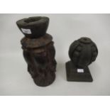 African carved hardwood candle stand, decorated with mask heads and a carved oak finial
