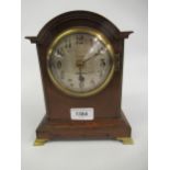 Small early 20th Century oak dome topped mantel clock, the silvered dial with Arabic numerals,
