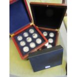 Two mahogany cased sets of eighteen silver proof five pound coins, of railway related subjects,