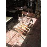 Pair of French wooden slatted and iron cafe chairs, bearing enamel label for ' Alain Menagerie '