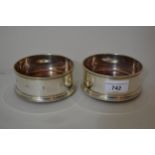 Pair of circular London silver bottle coasters with turned wooden bases