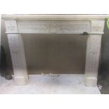 Large hand carved white marble fire surround having central leaf and foliate sprigs, supported by